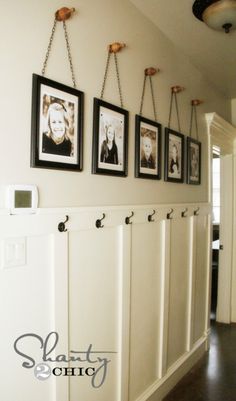 a hallway with pictures hanging on the wall