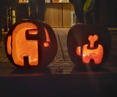 two pumpkins carved to look like people holding hands