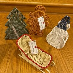 three wicker christmas trees with tags on them