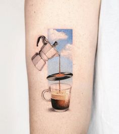 a person with a tattoo on their arm that has coffee being poured into a cup