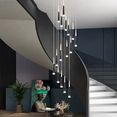 a modern chandelier hanging from the ceiling in a living room next to a staircase