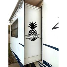 a white trailer with a black pineapple sticker on it's back door