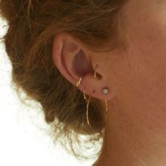 a close up of a person with ear piercings