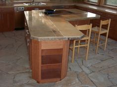 a kitchen with an island and chairs in it