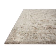 an area rug with faded colors and patterns on the bottom, in beiges and browns