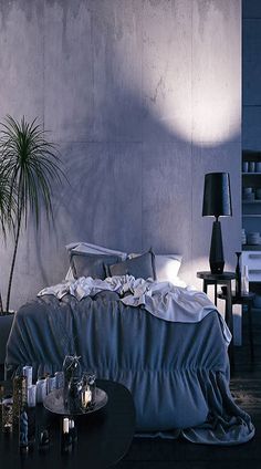 a bedroom with an unmade bed and two lamps on either side of the bed