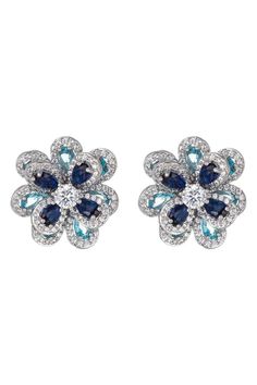 Blue flower petals decorate these small flower stud earrings placed in a CZ studded setting. These silver flower earrings are great for any day or nighttime look. Product Details - Silver tone brass earrings CZ crystal Closure - push-back Size - approx 1' length Silver Flower Earrings With Sparkling Stones, Blue Flower Earrings For Formal Occasions, Flower Shaped Earrings With Sparkling Stones, Silver Flower-shaped Crystal Earrings, Blue Flower Petals, Silver Flower Earrings, Flower Stud Earrings, Flower Stud, Stud Set