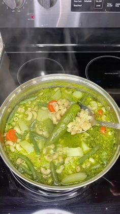 a pot filled with soup sitting on top of a stove