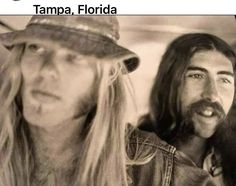 two people are sitting in a car and one is wearing a hat with long hair