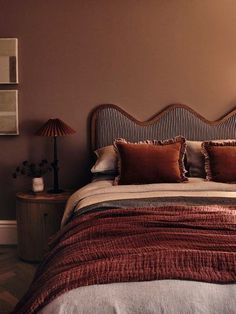 a bedroom with a bed and two lamps on the side tables in front of it