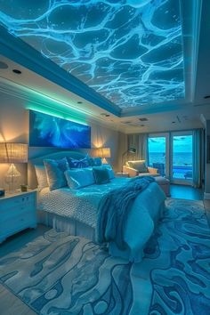 a bedroom with a large blue bed and ocean themed lighting on the ceiling is lit up by two lamps