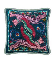 a decorative pillow with an animal design on the front and side, in blue and pink