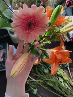 a person holding flowers in their hand