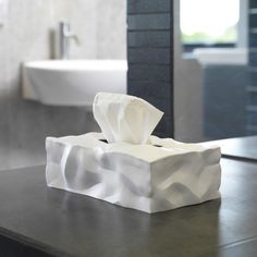 a tissue dispenser sitting on top of a counter