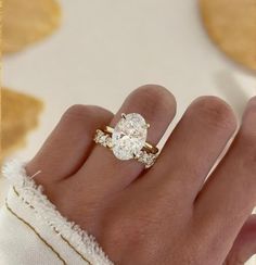 a woman's hand with a ring on it and a diamond in the middle