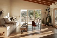 a living room filled with furniture and lots of windows