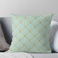 a blue and gold pillow sitting on top of a couch