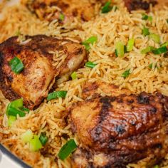 chicken and rice in a skillet with green onions on the side, ready to be eaten