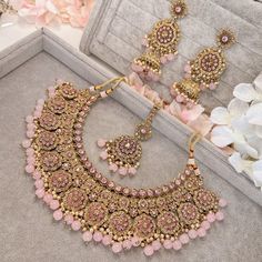 Beautifully flexible Antique Gold intricate necklace set scattered with dazzling golden crystals and light pink bead detailing Comes with matching long jhumka earrings (approx 3 inch length x 1.5 inch width) and matching tikka ( pendant part 2 inch length x 1.5 inch width)  Ready to ship as seen with gift box! Long Jhumka Earrings, Asian Bridal Jewellery, Pink Jewelry Set, Wedding Jewelry Sets Bridal Jewellery, Pakistani Bridal Jewelry, Perhiasan India, Indian Bridal Jewelry Sets, Fancy Jewellery Designs, Asian Jewelry