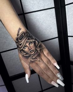 a woman's hand with a tattoo on it