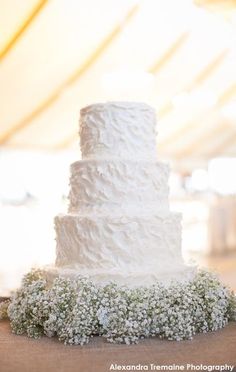 a white wedding cake sitting on top of a table