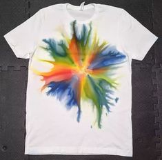 a white t - shirt with multicolored paint splattered on it