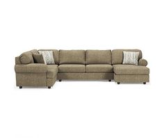 a large sectional couch with pillows on the top and bottom corner, in front of a white background