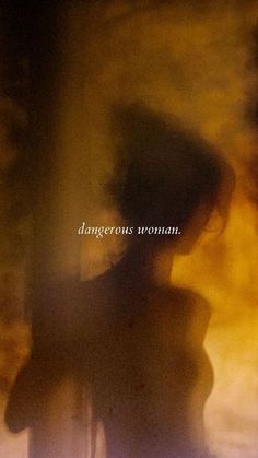 a blurry image of a woman standing in front of a window with the words dangerous woman on it