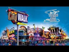 the city walk sign is in front of an amusement park with people walking around it