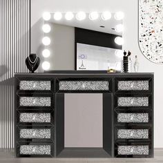 a vanity with lights on it in front of a mirror and other items around the room