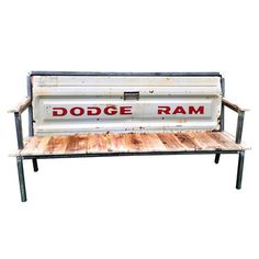 an old metal and wood bench with the word dodge ram written in red on it