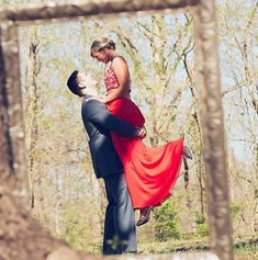 a man and woman are dancing in the woods