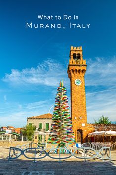 a colorful christmas tree in front of a clock tower with the words what to do in murano, italy