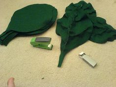 a green object is laying on the floor next to it's contents