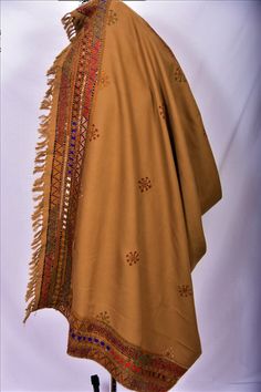 Shawl from Baluchistan, hand embroidered with cotton thread and small circular mirrors incorporated in the embroidery. This is traditional Baluchi style. Brown background with red, white, green, ivory work. Size: 86x42 inches One of a kind. Traditional Brown Pashmina Shawl With Patterns, Traditional Brown Embroidered Shawl, Brown Embroidered Dupatta Shawl, Traditional Embroidered Brown Shawl, Brown Embroidered Shawl Dupatta, Embroidered Brown Shawl Dupatta, Bohemian Beige Traditional Wear For Festive Occasions, Beige Bohemian Traditional Wear For Festive Occasions, Festive Bohemian Cream Traditional Wear