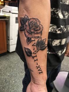 a person with a rose tattoo on their arm