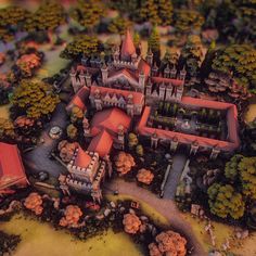 an aerial view of a castle surrounded by trees