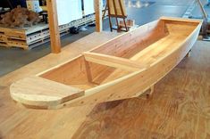 a wooden boat sitting on top of a hard wood floor