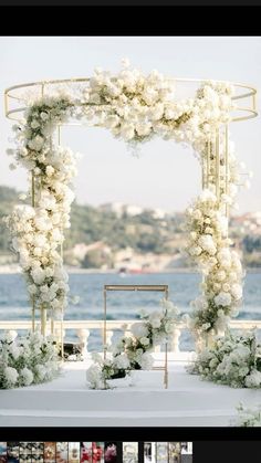 an outdoor ceremony setup with white flowers and greenery