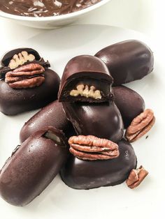 chocolate covered donuts with pecans in the middle