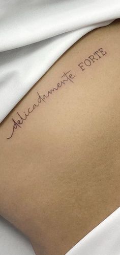 the back of a woman's arm with an inscription on it