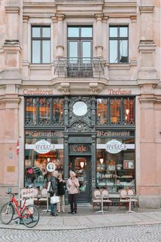 two people standing in front of a store