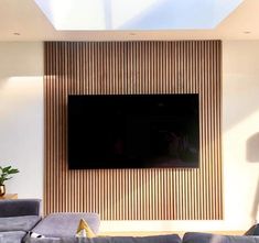 a large flat screen tv mounted to the side of a wall in a living room