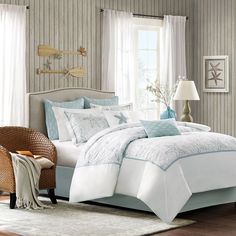 a bed with blue and white comforters in a bedroom