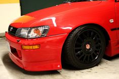 a red sports car parked in a garage