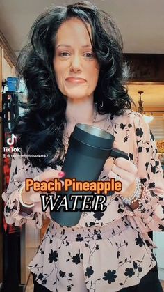 a woman holding a coffee cup in her right hand and looking at the camera with an ad for peach pineapple water