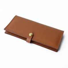 The Lincoln Park Wallet in tan is as sleek as its namesake neighborhood in Chicago. Crafted from beautiful vegetable tanned leather that wears wonderfully over time, this structured piece only gets better with age. The brass snap closure and K.Slade debossed logo polish off this wallet that can stylishly contain cash, receipts and up to twelve credit cards. Debossed Logo, Lincoln Park, Clutch Pouch, Small Pouches, Drawstring Pouch, Pencil Pouch, Zip Wallet, Custom Bags, Vegetable Tanned Leather