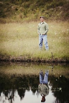 a man standing in front of a body of water