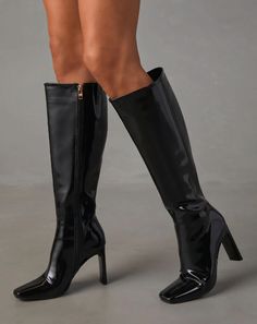 These high heeled boots sit right below the knee and offer a classy and elegant look, perfect for dressing up any outfit. 3.9" heel Closed pointed square toe Full zipper side closure Material: 100% Synthetic upper and lining, 100% Rubber outersole Chic Knee-length Evening Boots, Sleek Fall Party Platform Boots, Elegant Fitted Heeled Boots With Zipper, Chic Knee-length Party Boots, Sleek Knee-high Platform Boots For Party, Elegant Fitted Boots With Zipper Closure, High Ankle Heeled Boots With Zipper For Night Out, Chic Square Toe Boots For Night Out, Chic Knee-high Boots For Parties