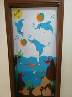 a door decorated with dolphins in the ocean